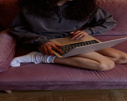 Person typing comfortably on a laptop indoors with good posture